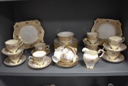 A vintage Plant Tuscan part tea service in a cream and gilt ground with floral details.