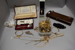 Costume jewellery including an assortment of yellow metal necklaces and bracelets.
