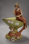 A Royal Dux figurine depicting classically dressed lady on shell, with foliage surrounding, 820