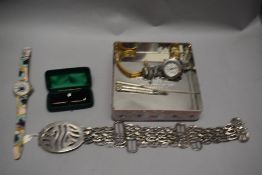 A Klaus Kobec mens wristwatch with a white metal belt and a tie pin.