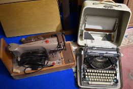 A vintage Olympia typewriter and Singer sewing machine