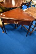 A reproduction mahogany corner table having frieze drawer