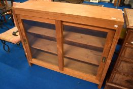 A vintage teak shop style bookcase, width sliding glazed doors , width approx. 120cm