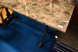 A marble top table having cast iron frame