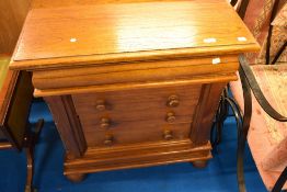 A modern oak chest having concealed frieze and three long drawers