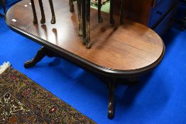 A modern mahogany effect coffee table of oval form, probably Rossmore