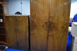 A 1930s design walnut two piece bedroom suite comprising bedroom and tallboy