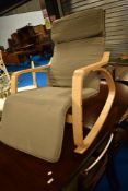 An Ikea easy chair having turned ply frame
