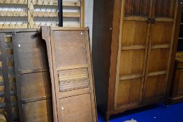 A mid 20th Century oak wardobe and bed frame, in the Priory style
