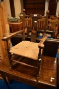A 19th Century rush seated child's rocking chair with inlaid back rail