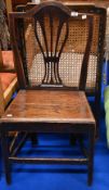 A Georgian oak solid seat dining chair having splat back