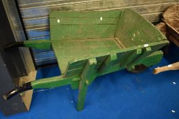 A vintage painted wooden wheelbarrow