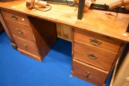 A Victorian pine pedestal desk or dressing table having brass aesthetic handles