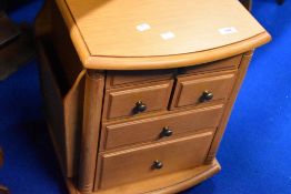 A modern beech effect trolley cabinet , with side pockets for magazine, knitting patterns or similar
