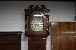 A Victorian long cased clock having mahogany case, with arch dial, 8 day movement and painted dial
