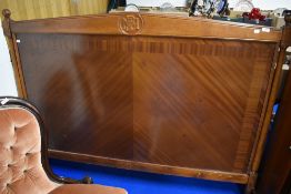A modern mahogany double headboard with monogram decoration, NHB