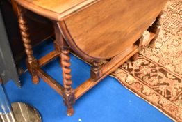 An early 20th Century oak twist gate leg dining table