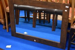 A modern mahogany effect wall mirror, approx 100 x 70cm