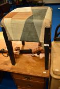A modern stool with vintage style upholstery