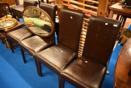 A set of four modern leatherette or bycast dining chairs
