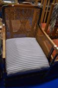 An early 20th century bergere armchair