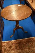 A 19th Century oak pedestal table having circular top , turned column and triple splay legs
