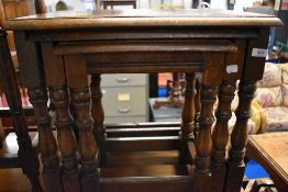 An early to mid 20th Century stained frame nest of three tables