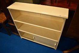 A vintage painted shelf unit with lower cupboard behind sliding doors , width approx. 93cm