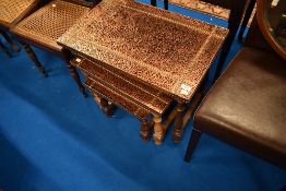 A vintage copper top nest of three occasional tables