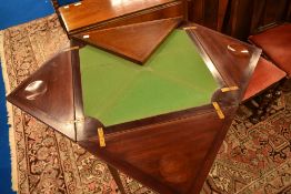 An Edwardian mahogany envelope card table having line inlay decoration, with frieze drawer and