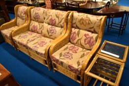 A modern wicker conservatory suite, comprising settee, two armchairs and two occasional tables