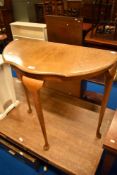 An early to mid 20th Century demi lune hall table