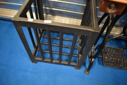 A heavy duty metal frame , probably for planter or waste bin, with wall brackets