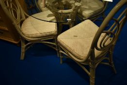 A bentwood and cane conservatory style dining suite comprising glass top table and five chairs