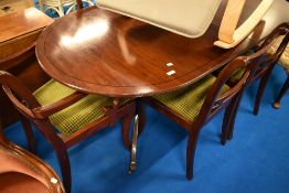 A reproduction Regency style dining table and six (four plus two) chairs