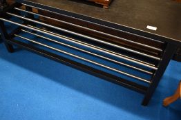 A black ash effect shelf/table with chrome rack under (possibly designed as shoe rack or coffee