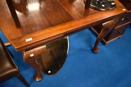 An early 20th Century mahogany drawer leaf table on heavy shaped legs