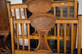 An Edwardian mahogany bed frame, width approx. 138cm (4ft6 double), includes irons and sprung base