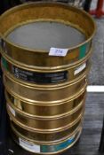 A set of seven scientific grade Laboratory test sieves.