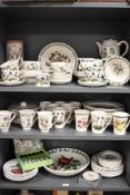 Over three shelves of Portmeirion Botanical Garden and Pomona pattern dinner, tea and dessert wares.