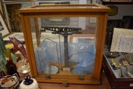 A set of Phillip Harris apothecary or chemist scales in a fitted oak case.