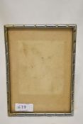 An Indian white metal photograph frame, of rectangular form with rope-twist type decoration,