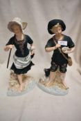 A pair of antique German bisque figure studies of a boy and girl fisherman.
