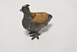 A Victorian miniature pewter pin cushion cast in the form of a farm yard Hen.