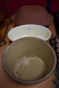 An early 20th century cream bowl with a terracotta cooking pot and similar.