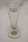 An 18th century fluted ale glass with writhen form body and domed foot with pontil break.
