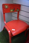 Two vintage child's chairs both painted in gloss red.