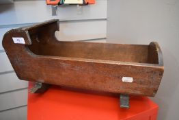 A small Victorian childs or dolls wooden rocking crib with hooded top.