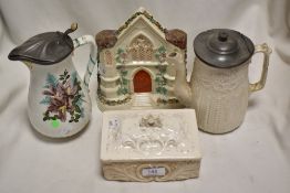A Bristolia butter dish with a Parian ware water jug and similar water jug and a Staffordshire