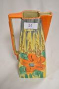 A Wadeheath Art Deco jug of stylised design with hand painted floral pattern.